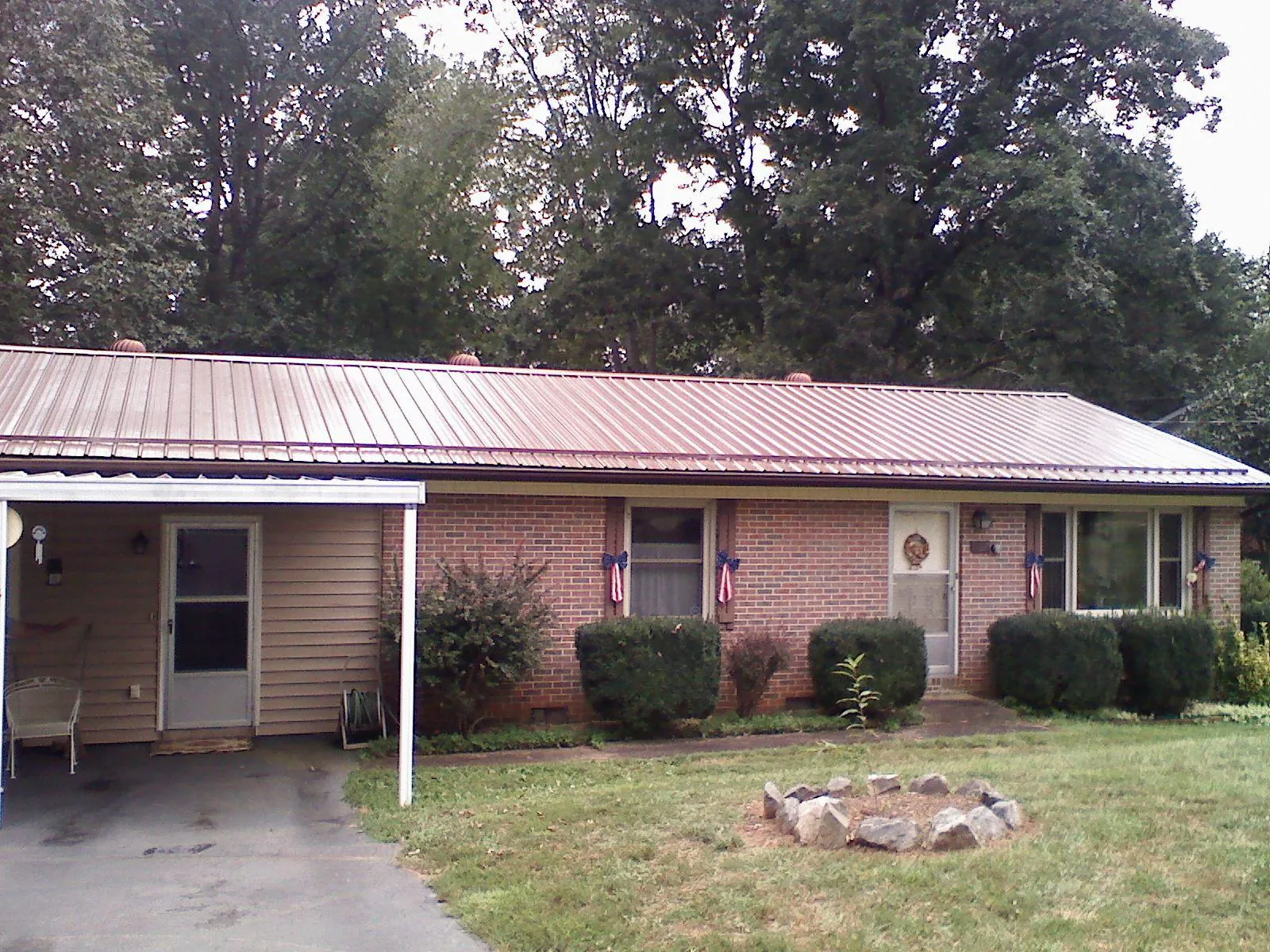 Bronze metal roof and carport on a brick ranch home — Roof Repair work by our crew in Blue Ridge Summit